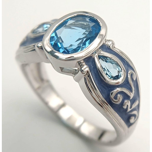 1154 - A Sterling Silver. Blue Topaz and Enamel Ring Size X. The Ring is set with a 1cm Long Centre Blue To... 