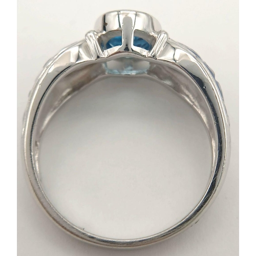 1154 - A Sterling Silver. Blue Topaz and Enamel Ring Size X. The Ring is set with a 1cm Long Centre Blue To... 