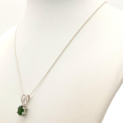 1159 - A 925 sterling silver pendant necklace featuring an oval-cut emerald-green stone, set on 41.2cm silv... 