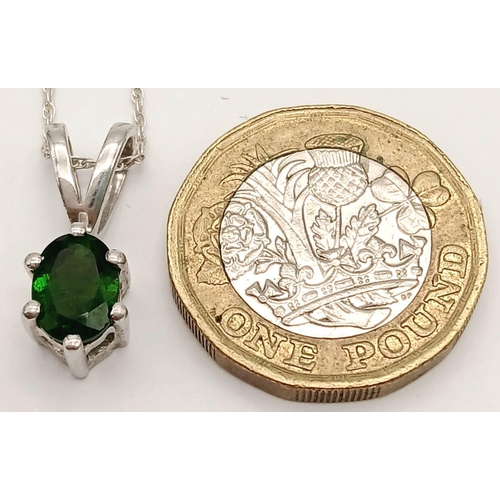 1159 - A 925 sterling silver pendant necklace featuring an oval-cut emerald-green stone, set on 41.2cm silv... 