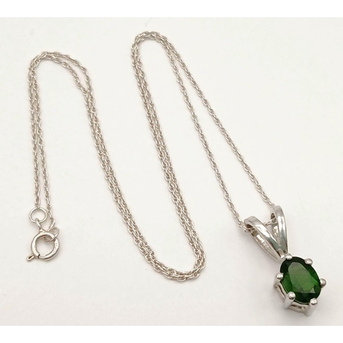 1159 - A 925 sterling silver pendant necklace featuring an oval-cut emerald-green stone, set on 41.2cm silv... 