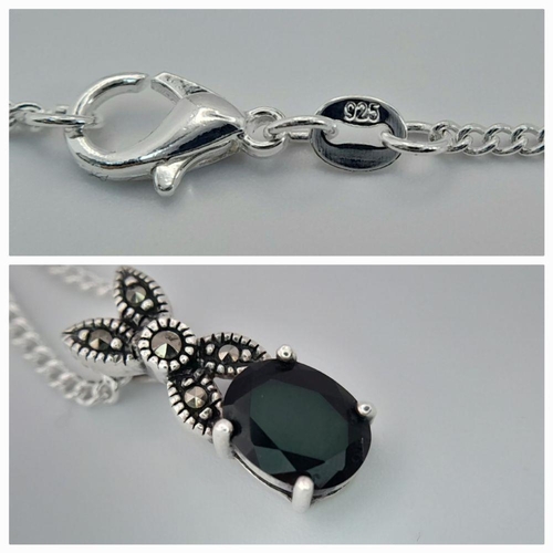 1583 - A sterling silver necklace with a sapphire set drop pendant. Approx 50cm in length with a pendant si... 