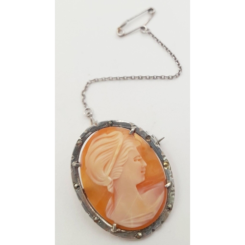 1639 - An Antique Cameo Brooch in a Silver Frame with Safety Chain.