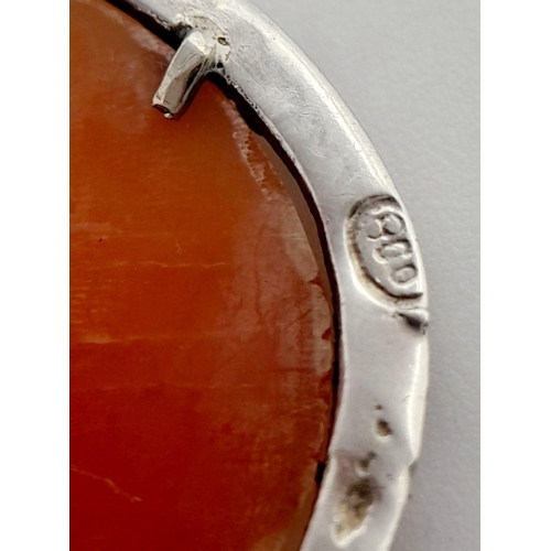 1639 - An Antique Cameo Brooch in a Silver Frame with Safety Chain.