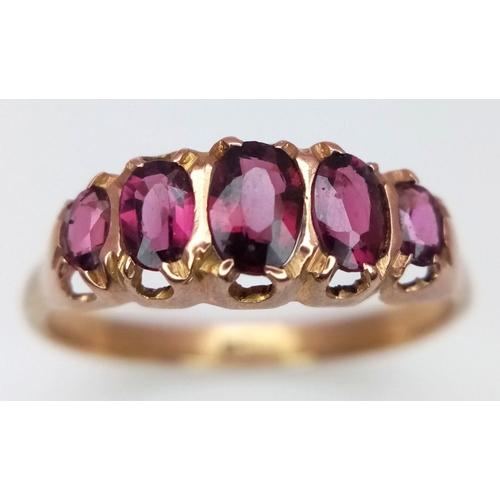 553 - Impressive 9 carat GOLD and GARNET RING. Consisting a sweep of  5 x OVAL CUT GARNETS mounted to top ... 