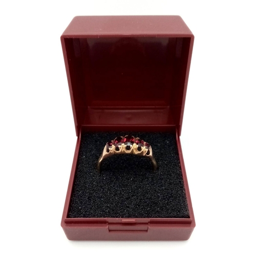 553 - Impressive 9 carat GOLD and GARNET RING. Consisting a sweep of  5 x OVAL CUT GARNETS mounted to top ... 