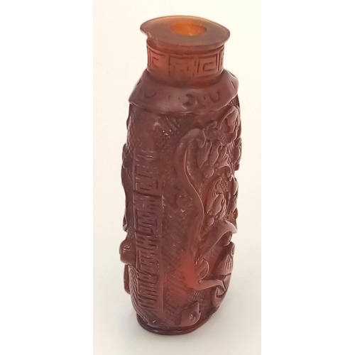 642 - An Antique Chinese Amber Hand-Carved Snuff Bottle. 6.5cm tall.