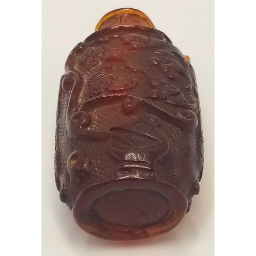 642 - An Antique Chinese Amber Hand-Carved Snuff Bottle. 6.5cm tall.