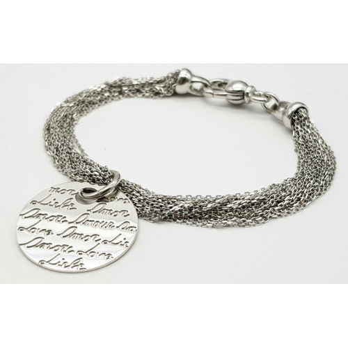 895 - A STERLING SILVER MULTI STRAND BRACLET WITH LARGE CHARM ENGRAVED WITH THE WORD LOVE IN MANY LANGUAGE... 