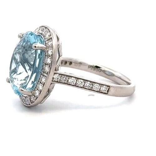 528 - A Platinum AQUA and DIAMOND Cluster Ring. 7.12ct claw set round shape Aqua centre, decorated with 0.... 