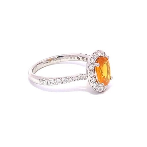 569 - A Platinum YELLOW SAPPHIRE and DIAMOND Cluster Ring. 1.71ct claw set oval shape Yellow Sapphire cent... 