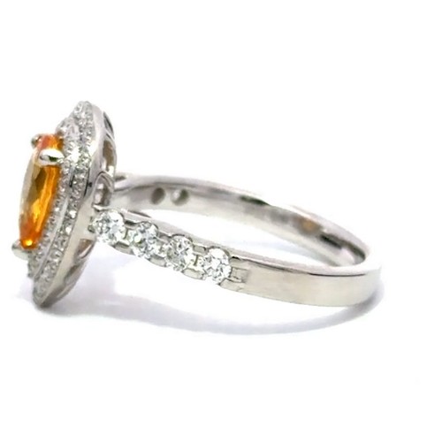 576 - A Platinum YELLOW SAPPHIRE and DIAMOND Cluster Ring. 1.29ct claw set oval shape Yellow Sapphire cent... 