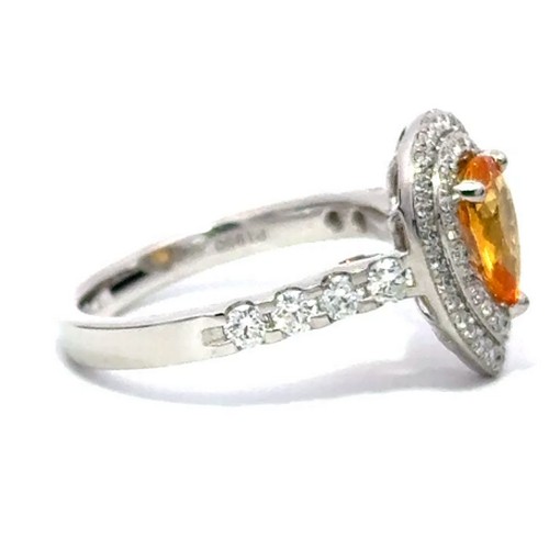 576 - A Platinum YELLOW SAPPHIRE and DIAMOND Cluster Ring. 1.29ct claw set oval shape Yellow Sapphire cent... 