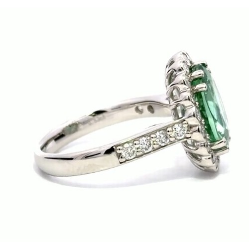 638 - A Platinum MINT TOURMALINE and DIAMOND Cluster Ring. 3.52ct claw set oval shape Mint Tourmaline cent... 