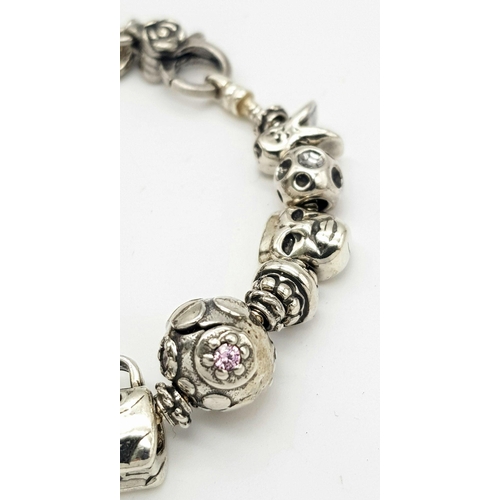 1098 - A Sterling Silver Charm Bracelet. 19cm Length. Gross Weight 42.36 Grams.