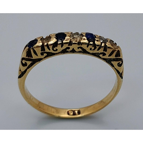 1653 - An 18K Gold Blue and White Stone Ring. Size M. 2.45g total weight.