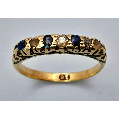 1653 - An 18K Gold Blue and White Stone Ring. Size M. 2.45g total weight.