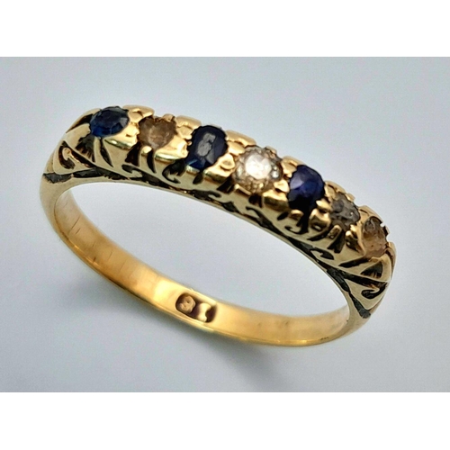 1653 - An 18K Gold Blue and White Stone Ring. Size M. 2.45g total weight.