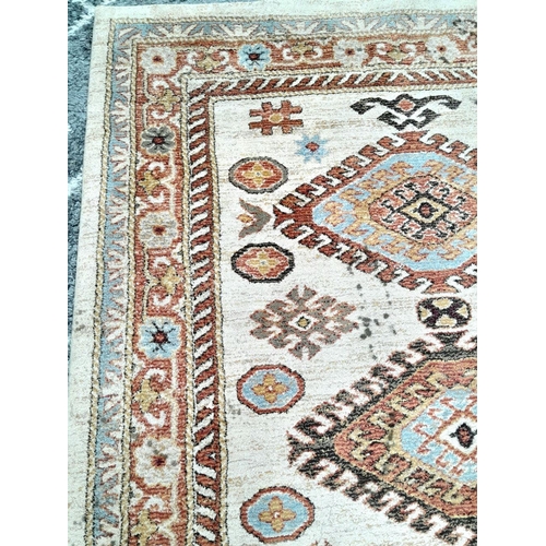 928 - A Cream Cashmere Patterned Rug, Measuring 200 x 290cm. See photos for condition and design.