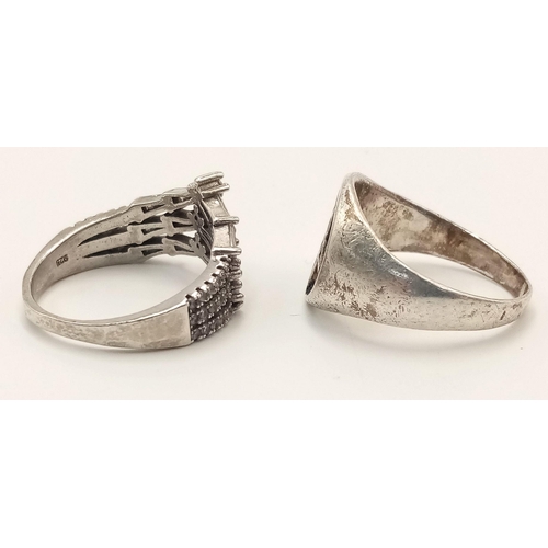 1597 - Two sterling silver rings, ring sizes M 1/2 and O 1/2, weighing a total of 8.2g. One ring showcases ... 