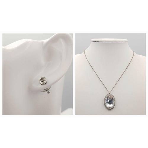 1612 - A matching set of Swarovski large Crystal pendant on chain and a pair of stone set earrings.