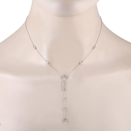 1396 - A 14K White Gold 0.70ct Diamond Necklace. It features petite clusters of round and baguette diamonds... 