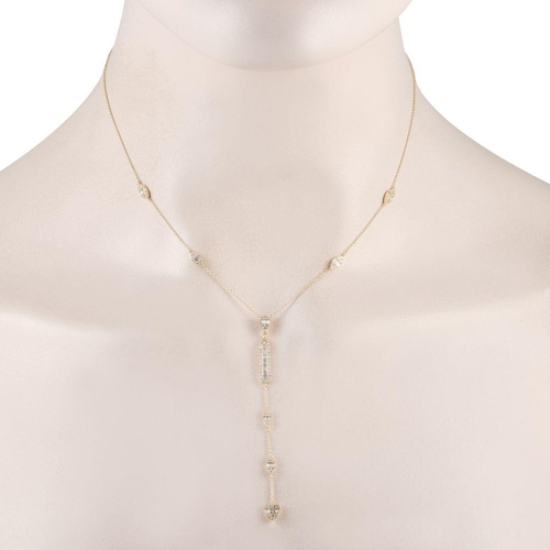 1403 - A 14K Yellow Gold 0.70ct Diamond Necklace. It features petite clusters of round and baguette diamond... 