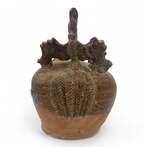 1163 - A 16th century Quang Duc Vietnamese Ceramic mineral lime pot featuring a rounded body and ornate han... 