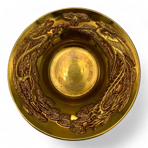 1376 - A Chinese Gold-Toned Dragon and Phoenix Tea Bowl with Saucer.  
Gold-toned bronze exterior with intr... 