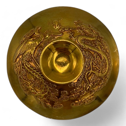 1376 - A Chinese Gold-Toned Dragon and Phoenix Tea Bowl with Saucer.  
Gold-toned bronze exterior with intr... 