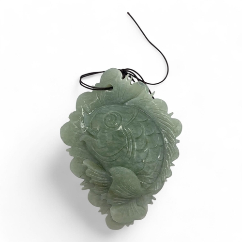 1383 - A vintage Chinese Green Jade Serpentine Fish Pendant on Ornate Black Stand. Serpentine green pendant... 