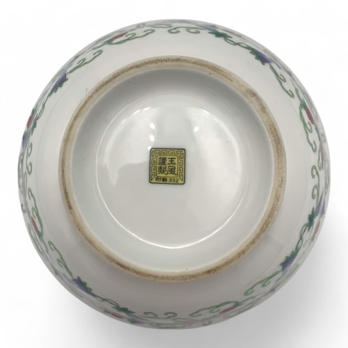 1397 - An antique Chinese Porcelain Bowl with Floral and Butterfly Design. White porcelain with green, red,... 