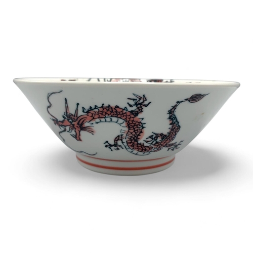 1418 - A Japanese Porcelain Dragon Bowl.  
White porcelain with pink and black dragon motif exterior, adorn... 