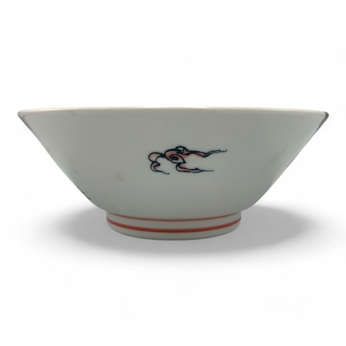 1418 - A Japanese Porcelain Dragon Bowl.  
White porcelain with pink and black dragon motif exterior, adorn... 