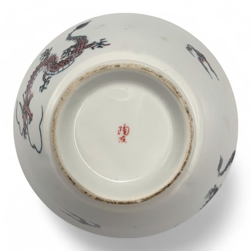 1418 - A Japanese Porcelain Dragon Bowl.  
White porcelain with pink and black dragon motif exterior, adorn... 