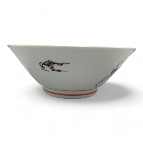 1418 - A Japanese Porcelain Dragon Bowl.  
White porcelain with pink and black dragon motif exterior, adorn... 