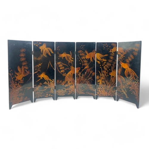 1523 - A vintage Chinese Black Lacquer Folding Screen with Gold Hand-Painted Koi and Landscape Motifs.
Blac... 