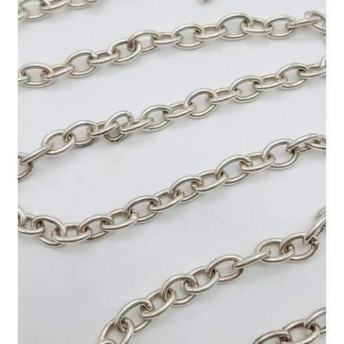 1083 - A Sterling Silver Chain with T-Bar Clasp and Cross Charm. 36cm. 14.75g