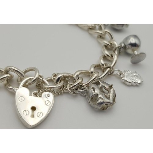 632 - A beautiful Solid Silver 925 Charm Bracelet, with 12 charms, 40 grams, 19cm. Condition: Like New.