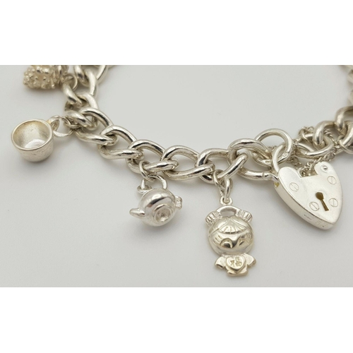 632 - A beautiful Solid Silver 925 Charm Bracelet, with 12 charms, 40 grams, 19cm. Condition: Like New.