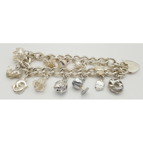 632 - A beautiful Solid Silver 925 Charm Bracelet, with 12 charms, 40 grams, 19cm. Condition: Like New.