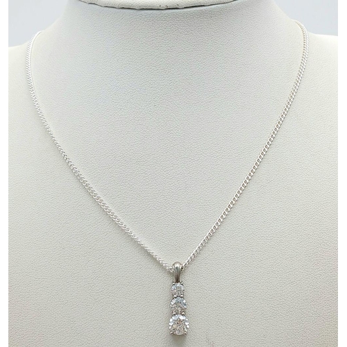 1569 - A 925 sterling silver drop pendant necklace with clear stones. Approx 50.3cm in length, a 2.3cm pend... 