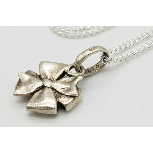 1590 - Two 925 Silver Necklaces with Pendants - bow and abstract design. 2.3cm bow pendant, 3.1cm abstract ... 