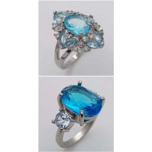 814 - Two sterling silver 925 rings, each showcasing striking blue gemstones: one features a bold oval-cut... 