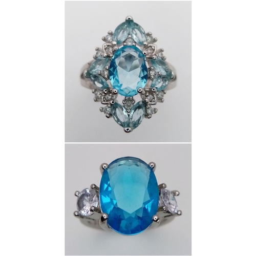 814 - Two sterling silver 925 rings, each showcasing striking blue gemstones: one features a bold oval-cut... 