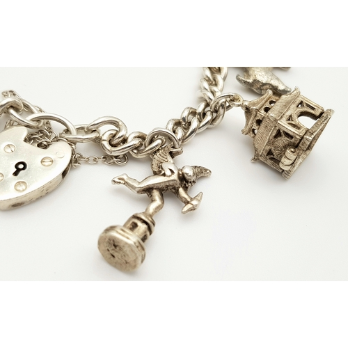 764 - A beautiful vintage Solid Silver 925 Charm Bracelet, with 9 charms, Heart Padlock and safety chain, ... 