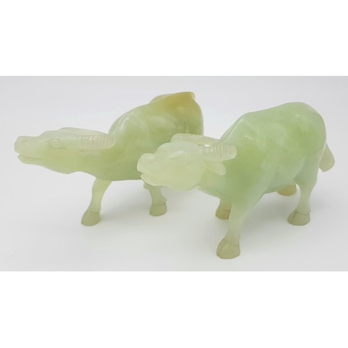 795 - An Antique Pair of Chinese Hand-Carved Green Hardstone Water Buffalo Figures. 15cm length. 8cm tall.... 