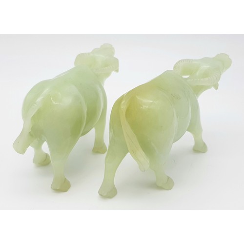 795 - An Antique Pair of Chinese Hand-Carved Green Hardstone Water Buffalo Figures. 15cm length. 8cm tall.... 