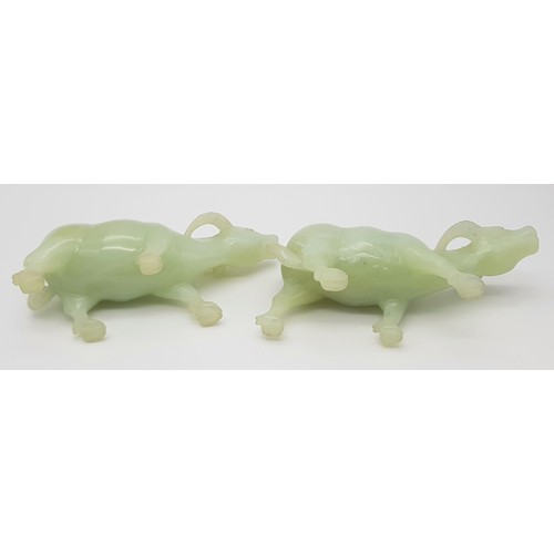 795 - An Antique Pair of Chinese Hand-Carved Green Hardstone Water Buffalo Figures. 15cm length. 8cm tall.... 