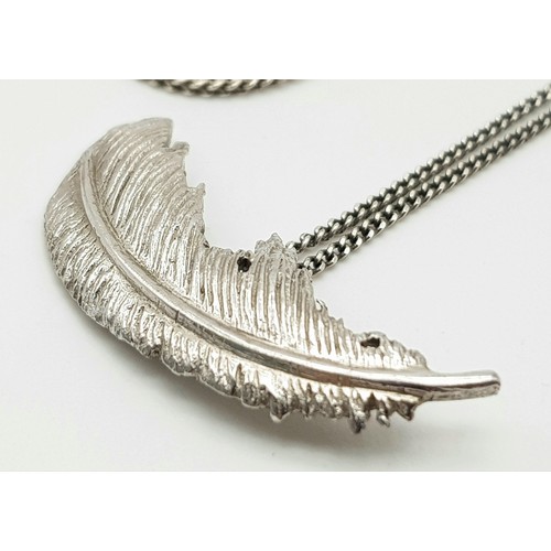 1564 - Two sterling silver pendant necklaces, to include one CZ stone set pendant and a curved feather-like... 